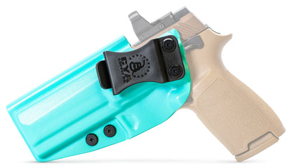 CYA Full size Holster in teal blue with a black clip on a tan sig sauer p320 handgun